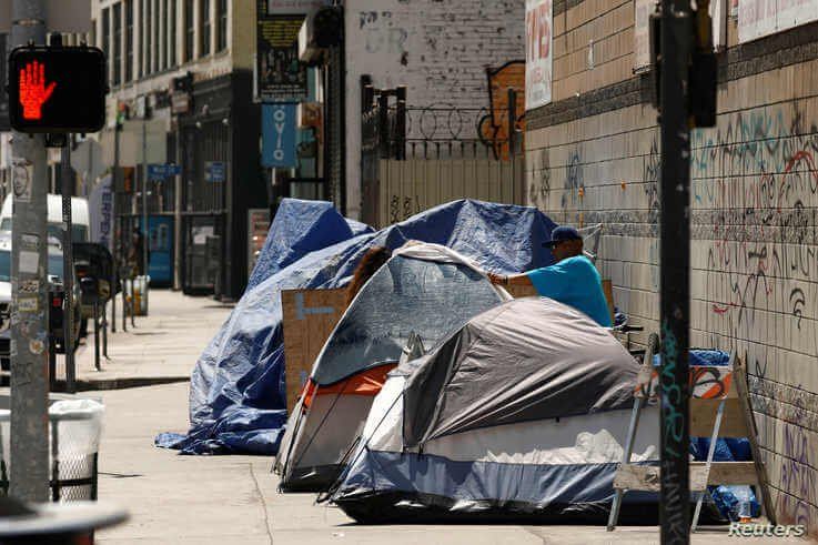 Tents and tarps erected by homeless people are shown along sidewalks and streets in the skid row area of downtown Los Angeles,…