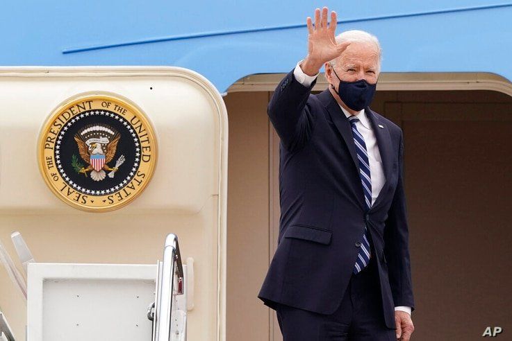 President Joe Biden waves from the top of the steps of Air Force One at Andrews Air Force Base, Md., Tuesday, March 16, 2021,…