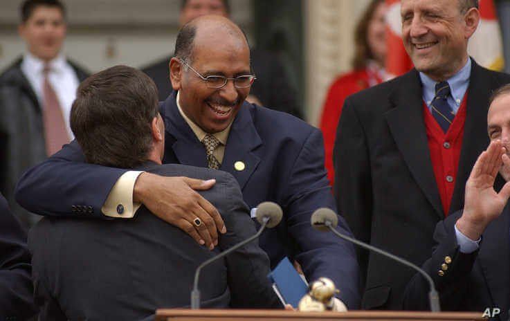 Lt. Governor Michael Steele embraces Maryland Gov. Robert Ehrlich at a rally on April 25, 2003, on the steps of the Statehouse in Annapolis, Md.