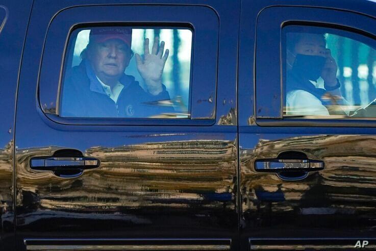 President Donald Trump waves to supporters from his motorcade as people gather for a march Saturday, Nov. 14, 2020, in…