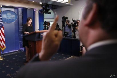 Brian Karem, right, White House correspondent for Playboy magazine, gestures as he reacts to responses by then-White House press secretary Sarah Huckabee Sanders, left, during a daily briefing at the White House, in Washington, June 14, 2018.