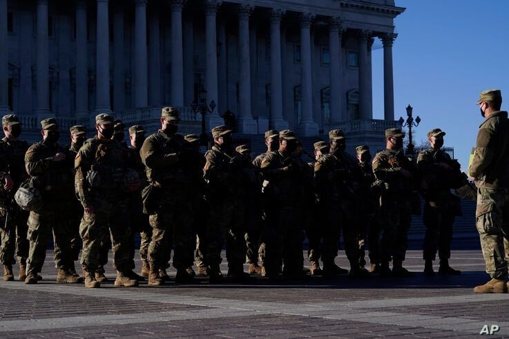 National Guard troops reinforce the security zone on Capitol Hill in Washington, Tuesday, Jan. 19, 2021, before President-elect…