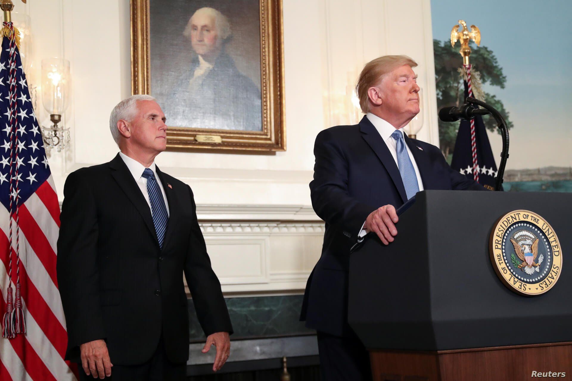 President Donald Trump speaks about the shootings in El Paso and Dayton as Vice President Mike Pence looks on in the Diplomatic Room of the White House in Washington, Aug. 5, 2019.