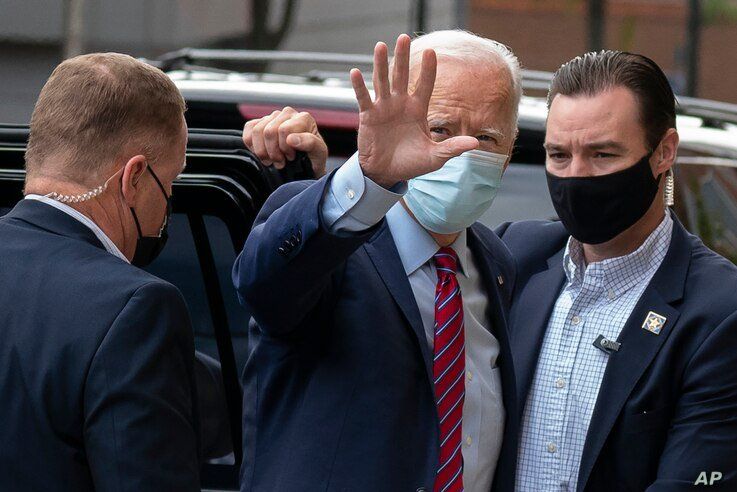 Democratic presidential candidate former Vice President Joe Biden waves as he arrives at The Queen theatre in Wilmington, Del.,…