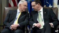 Attorney General Jeff Sessions speaks with Deputy Attorney General Rod Rosenstein, during the opening of the summit on Efforts to Combat Human Trafficking at Department of Justice in Washington, Feb. 2, 2018.