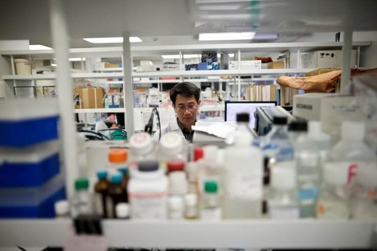 In this March 4, 2015 photo, research scientist Tony Huang works in a laboratory at Vertex Pharmaceuticals Inc. in San Diego…