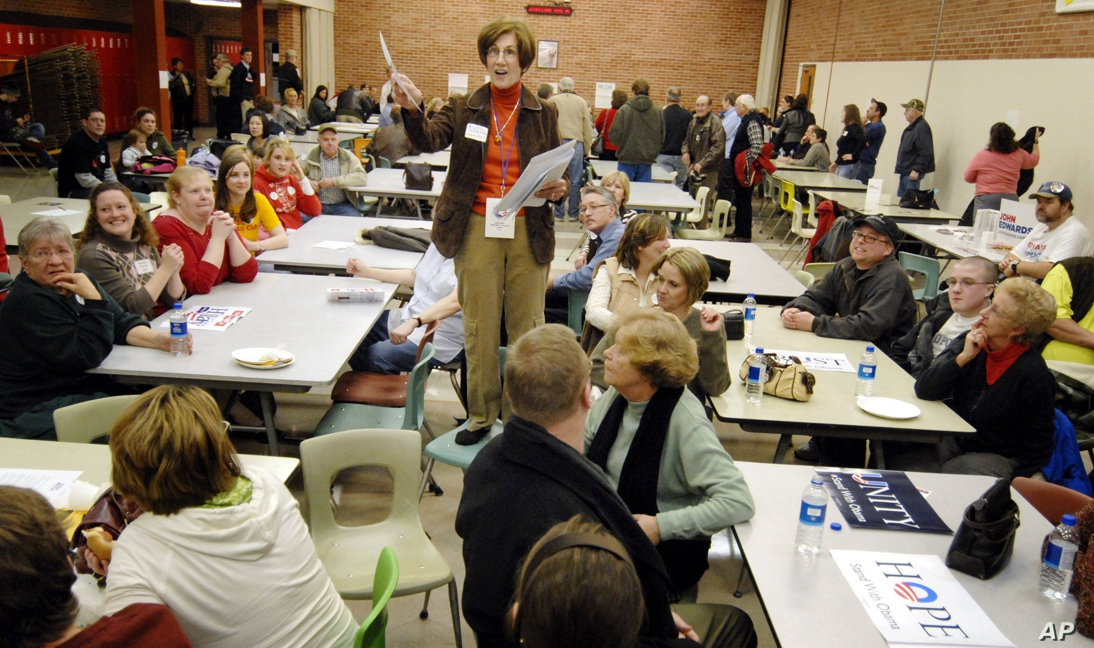 FILE - Precinct Chairwoman Judy Wittkop explains the rules during a caucus in Le Mars, Iowa, Jan. 3, 2008.