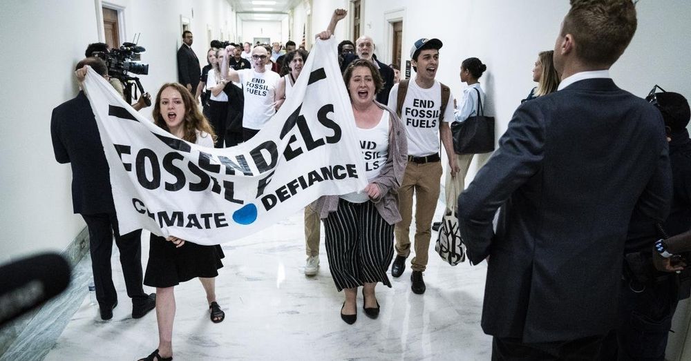 In protest against fossil fuel use, Climate Defiance blocks unused entrance to DOE garage