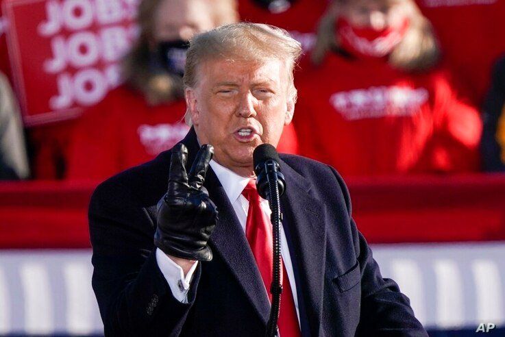 President Donald Trump speaks at a campaign rally Friday, Oct. 30, 2020, at the Austin Straubel Airport in Green Bay, Wis. (AP…