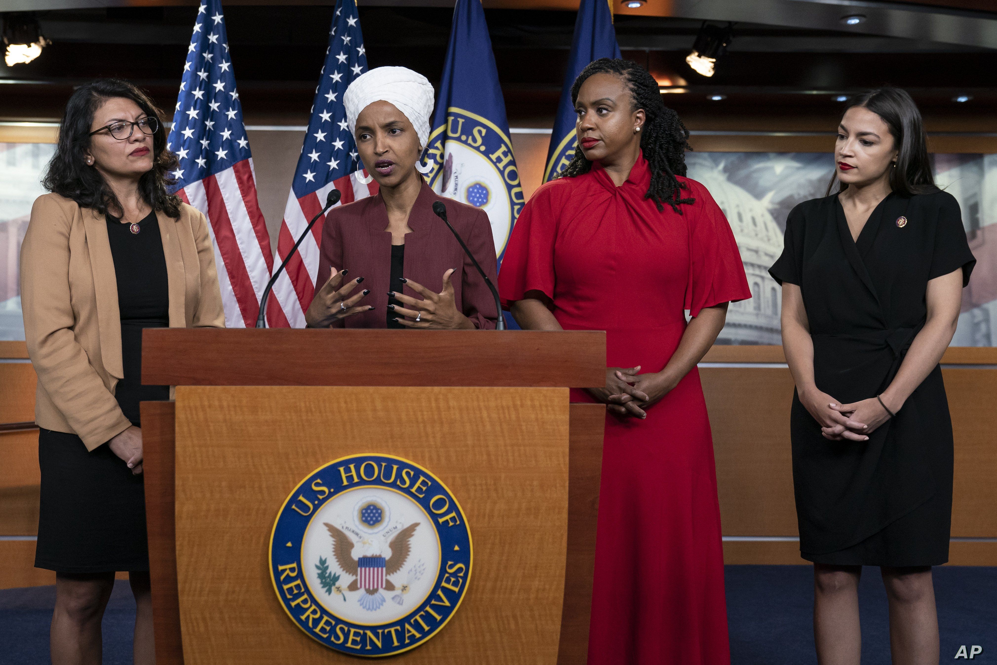 From left, U.S. Reps. Rashida Tlaib, Ilhan Omar, Ayanna Pressley and Alexandria Ocasio-Cortez respond to base remarks by President Donald Trump, at the Capitol in Washington, July 15, 2019. Tuesday, the House voted to condemn Trump for his comments.