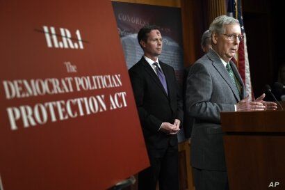Senate Majority Leader Mitch McConnell of Ky., right, speaks during a news conference on Capitol Hill in Washington, Wednesday,…