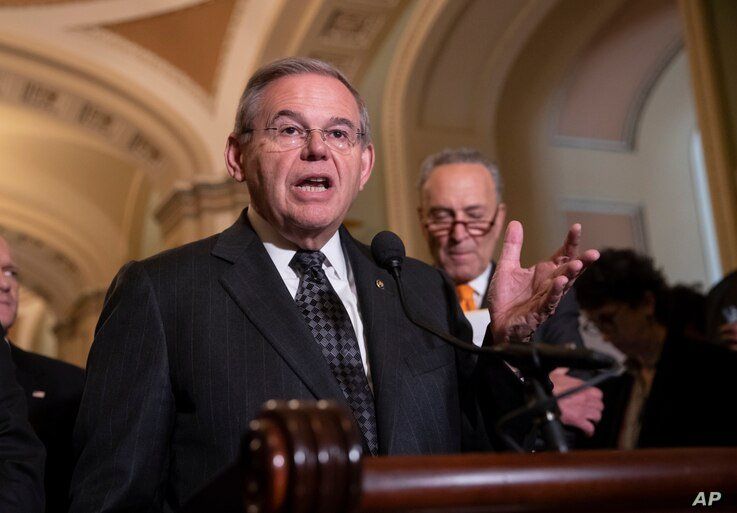 Sen. Bob Menendez, D-N.J., the ranking member of the Senate Foreign Relations Committee, joined at right by Senate Minority…