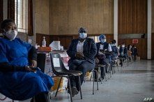 Health care workers awaits doses to start vaccinating people with Pfizer vaccines at the Bertha Gxowa Hospital in Germiston, on…
