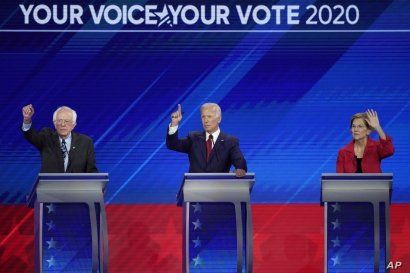 From left, Democratic presidential candidates Sen. Bernie Sanders, I-Vt., former Vice President Joe Biden and Sen. Elizabeth Warren, D-Mass. raise their hands to answer a question Thursday, Sept. 12, 2019, during a Democratic presidential primary…