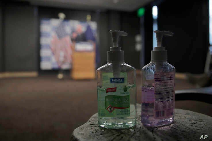 Hand sanitizer are placed near reporters as Democratic presidential candidate, Sen. Bernie Sanders, I-Vt., speaks about…