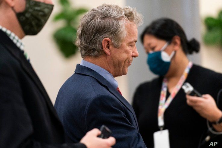 Reporters follow as Sen.Rand Paul, R-Ky., leaves the Capitol at the conclusion of the second day of the second impeachment…