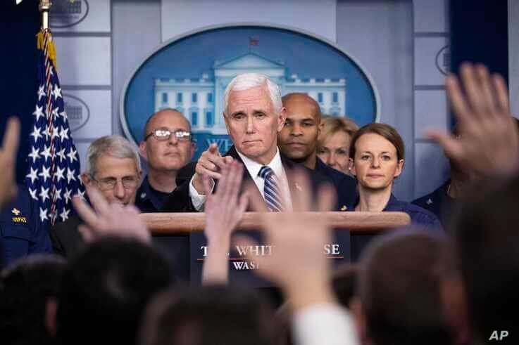 Vice President Mike Pence points to a question as he speaks during a briefing about the coronavirus in the James Brady Press Briefing Room of the White House, Sunday, March 15, 2020, in Washington.