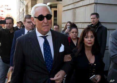 FILE - In this Nov. 15, 2019, file photo, Roger Stone, left, with his wife Nydia Stone, leaves federal court in Washington,…