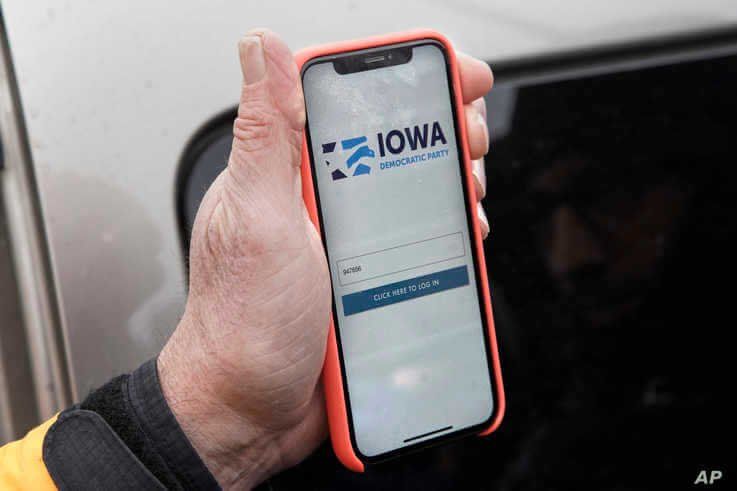 Precinct captain Carl Voss of Des Moines displays the Iowa Democratic Party caucus reporting app on his phone outside of the…