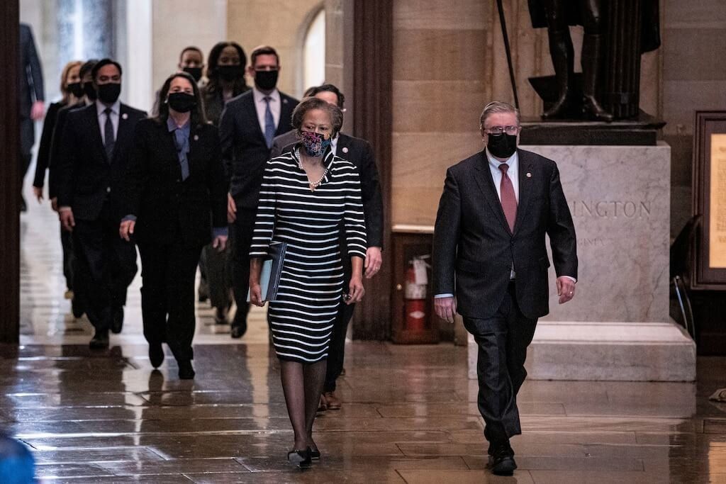 FILE PHOTO: House impeachment managers walk the article of impeachment against former U.S. President Donald Trump through the Rotunda of the U.S. Capitol