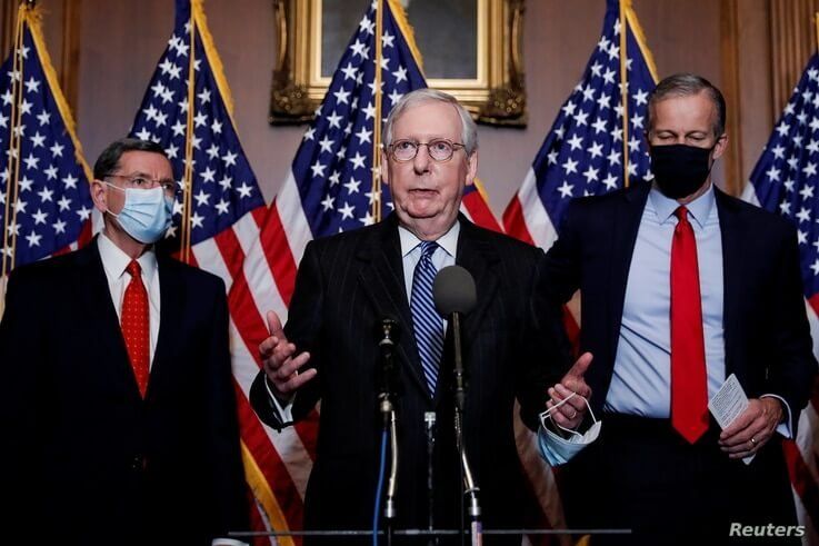 U.S. Senate Majority Leader Mitch McConnell (R-KY) is flanked by Senators John Barrasso R-WY) and John Thune (R-SD) as he…