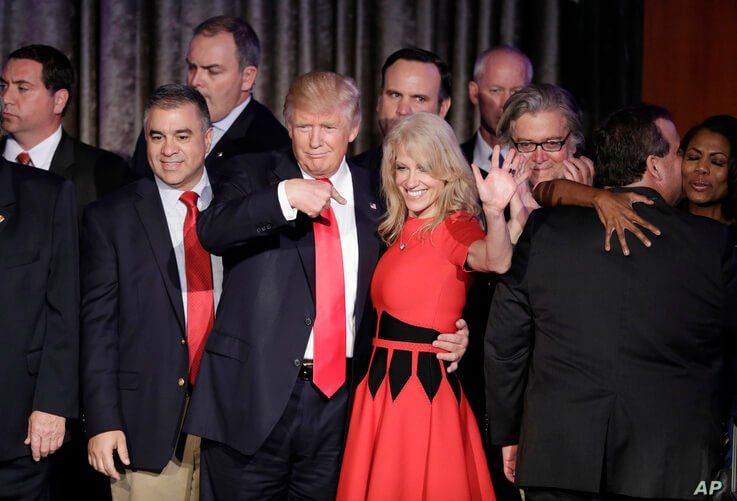   FILE - Then President-elect Donald Trump and campaign manager Kellyanne Conway celebrate during an election night rally.