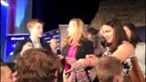 Chelsea Clinton autographs a tie