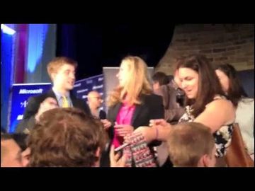 Chelsea Clinton autographs a tie