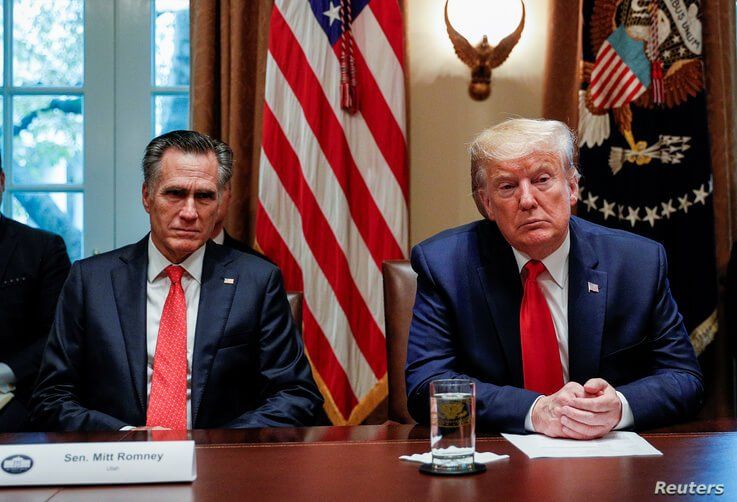 U.S. President Donald Trump listens to U.S. Senator Mitt Romney (R-UT) during a listening session on the regulation of nicotine…