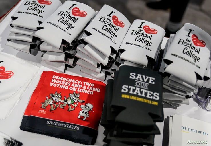Supporters of the Electoral College display items at the Conservative Political Action Conference (CPAC) annual meeting at…