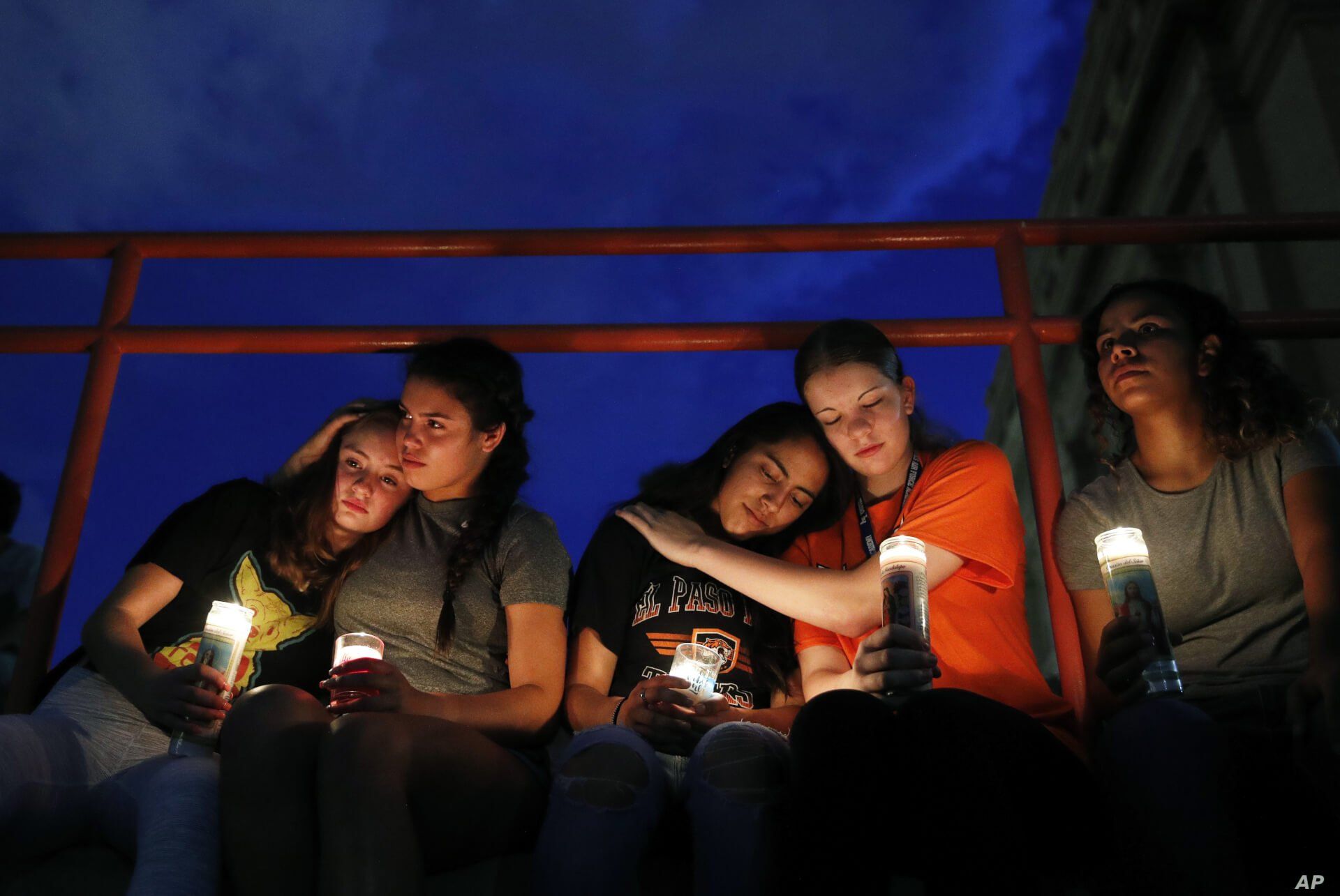 From left, Melody Stout, Hannah Payan, Aaliyah Alba, Sherie Gramlich and Laura Barrios comfort each other during a vigil for victims of the shooting Saturday, Aug. 3, 2019, in El Paso, Texas. A young gunman opened fire in an El Paso, Texas, shopping…