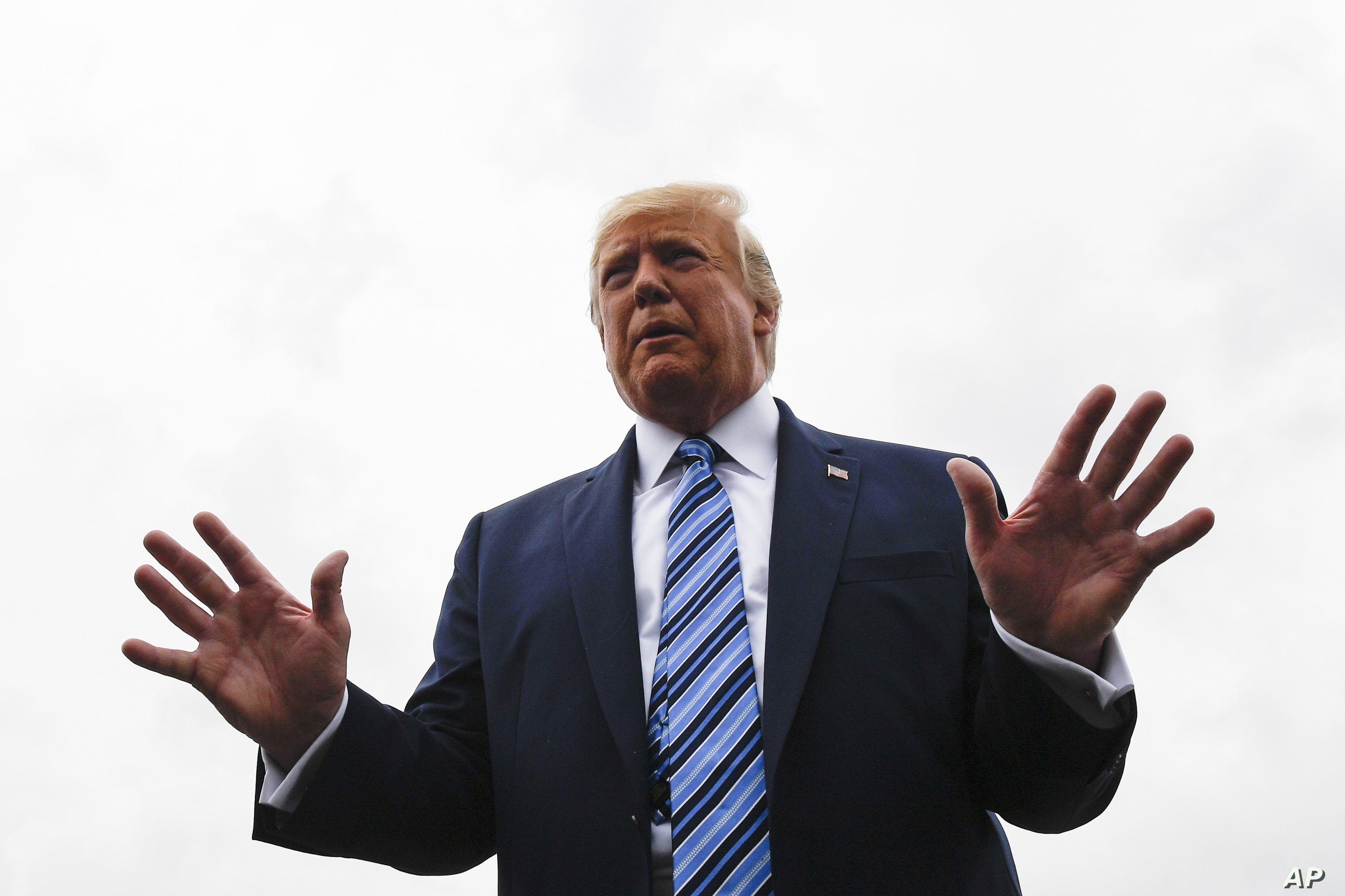 President Donald Trump talks to reporters at Morristown Municipal Airport in Morristown, N.J., Aug. 13, 2019.
