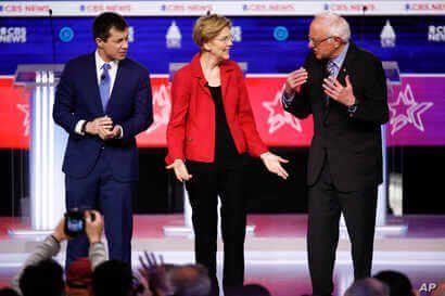 From left, former South Bend Mayor Pete Buttigieg, Sen. Elizabeth Warren, D-Mass., and Sen. Bernie Sanders, I-Vt., on stage as they participate in a Democratic presidential primary debate at the Gaillard Center, Tuesday, Feb. 25, 2020, in Charleston, S.C.