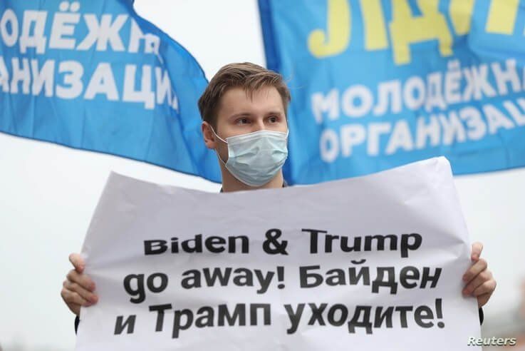 An activist of the Liberal Democratic Party of Russia (LDPR) holds a placard during a demonstration ahead of the U.S…