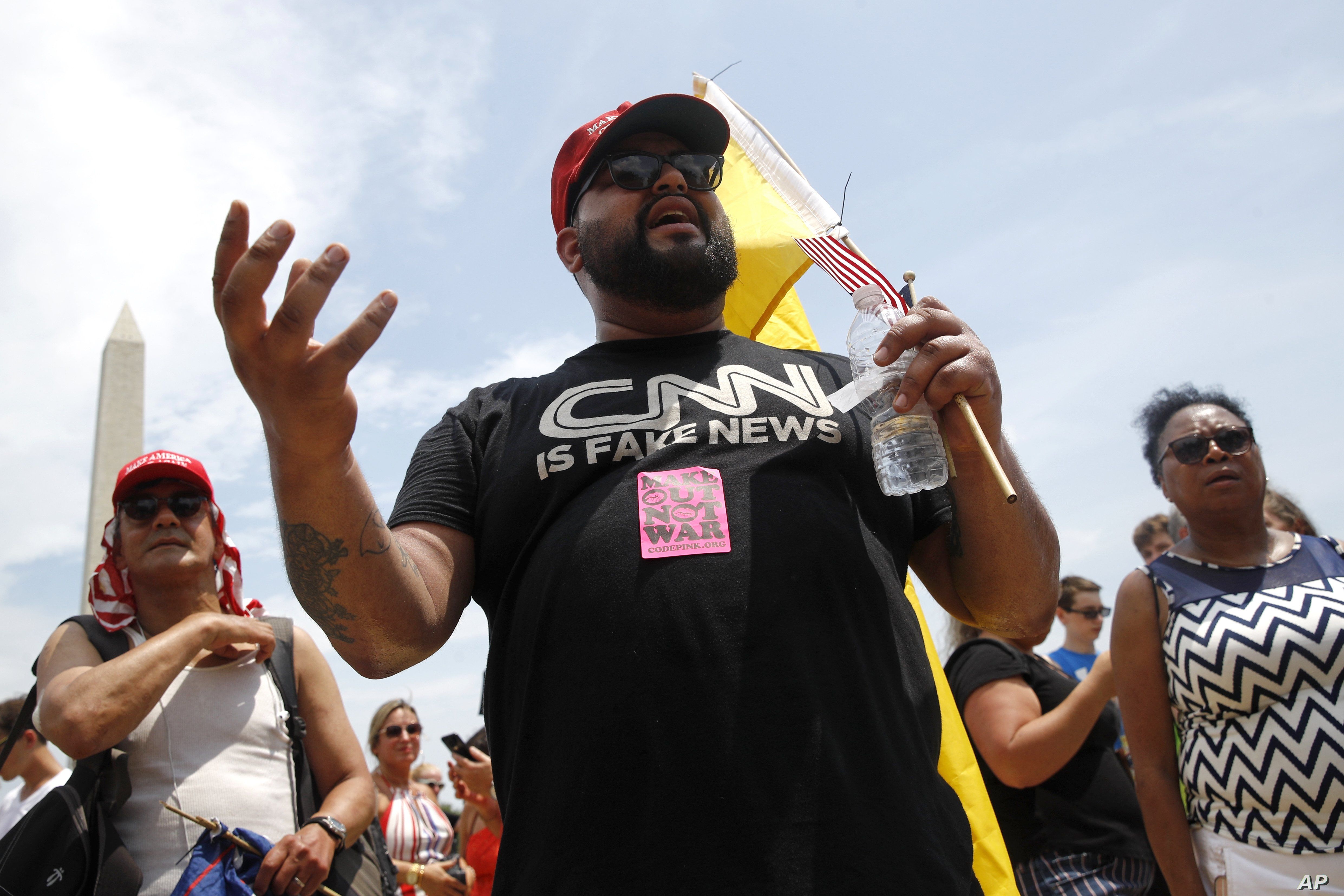 A supporter of President Donald Trump, who gave his name as Moto Moto of Brooklyn, N.Y., debates with protesters before Independence Day celebrations on the National Mall in Washington, July 4, 2019.