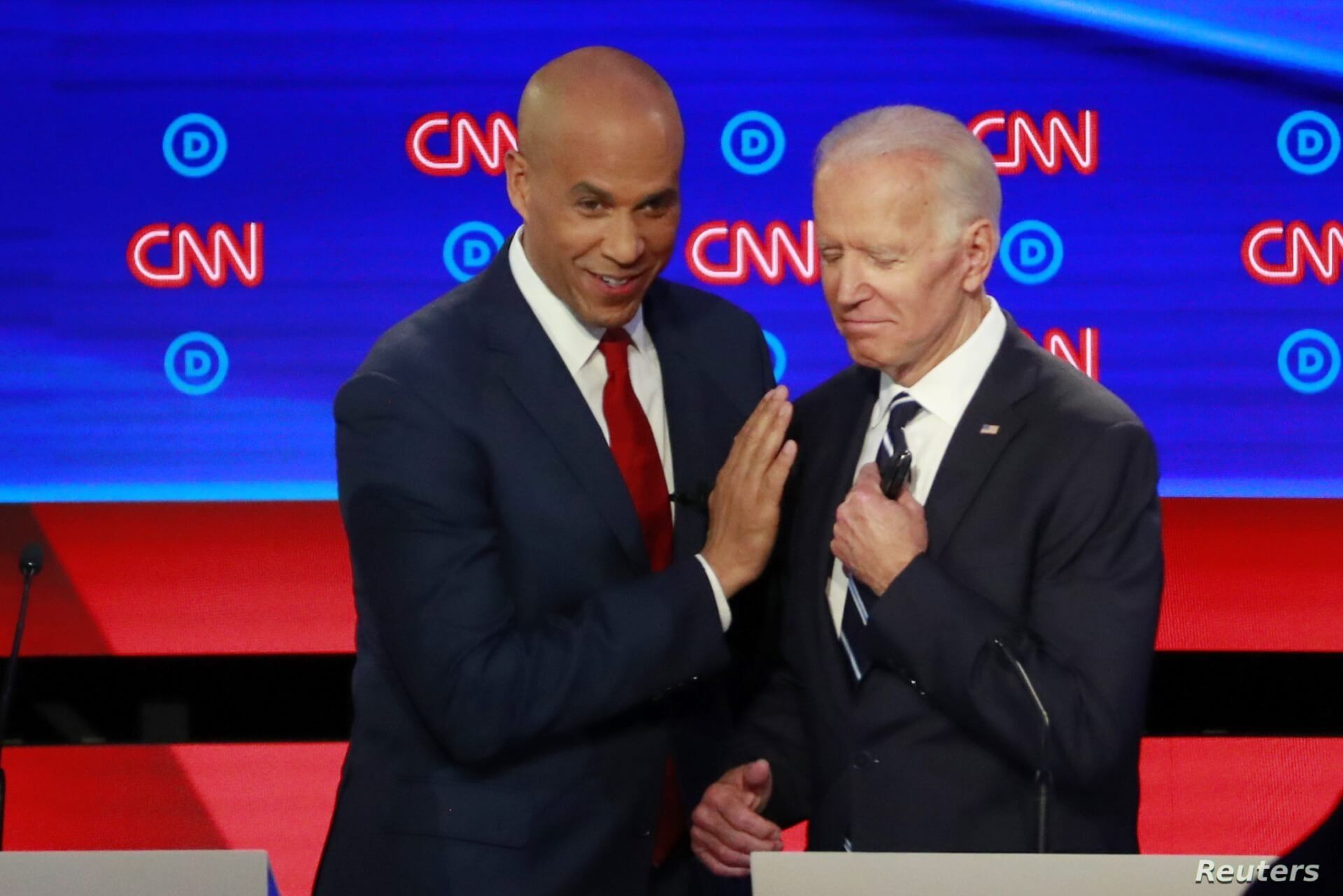 U.S. Senator Cory Booker and former Vice President Joe Biden talk during a commercial break on the second night of the second U.S. 2020 presidential Democratic candidates debate in Detroit, Michigan, U.S.