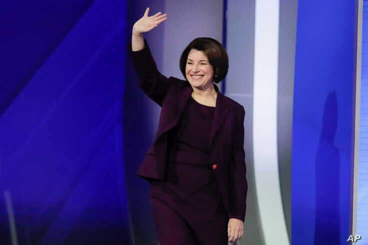 Sen. Amy Klobuchar, D-Minn., waves on stage Friday, Feb. 7, 2020, before the start of a Democratic presidential primary debate…