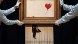 Shredded painting by British artist Banksy re-sold for $25.4 million at auction in London