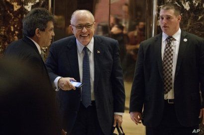 Former New York Mayor Rudy Giuliani, center, smiles as he leaves Trump Tower, Nov. 11, 2016, in New York.