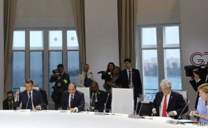 World leaders attend a session on climate change, in Biarritz, France, Aug. 26, 2019, on the third day of the annual G-7 Summit. The empty chair was reserved for U.S. President Donald Trump.