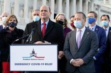 Problem Solvers Caucus co-chairs Rep. Tom Reed, R-N.Y., at podium, and Rep. Josh Gottheimer, D-N.J., right, speak to the media…