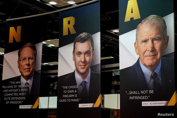 Images of NRA CEO Wayne LaPierre, Legislative Director Chris Cox and President Oliver North displayed during the National Rifle…