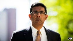 Dinesh D'Souza exits the Manhattan Federal Courthouse after pleading guilty in New York, May 20, 2014. D'Souza pleaded guilty to one criminal count of making illegal contributions in the names of others.