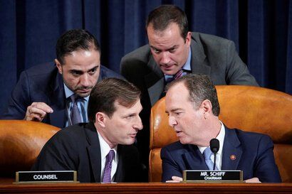 House Intelligence Committee Chairman Adam Schiff (D-CA) speaks with Democratic Counsel Daniel Goldman (L) and other staffers…