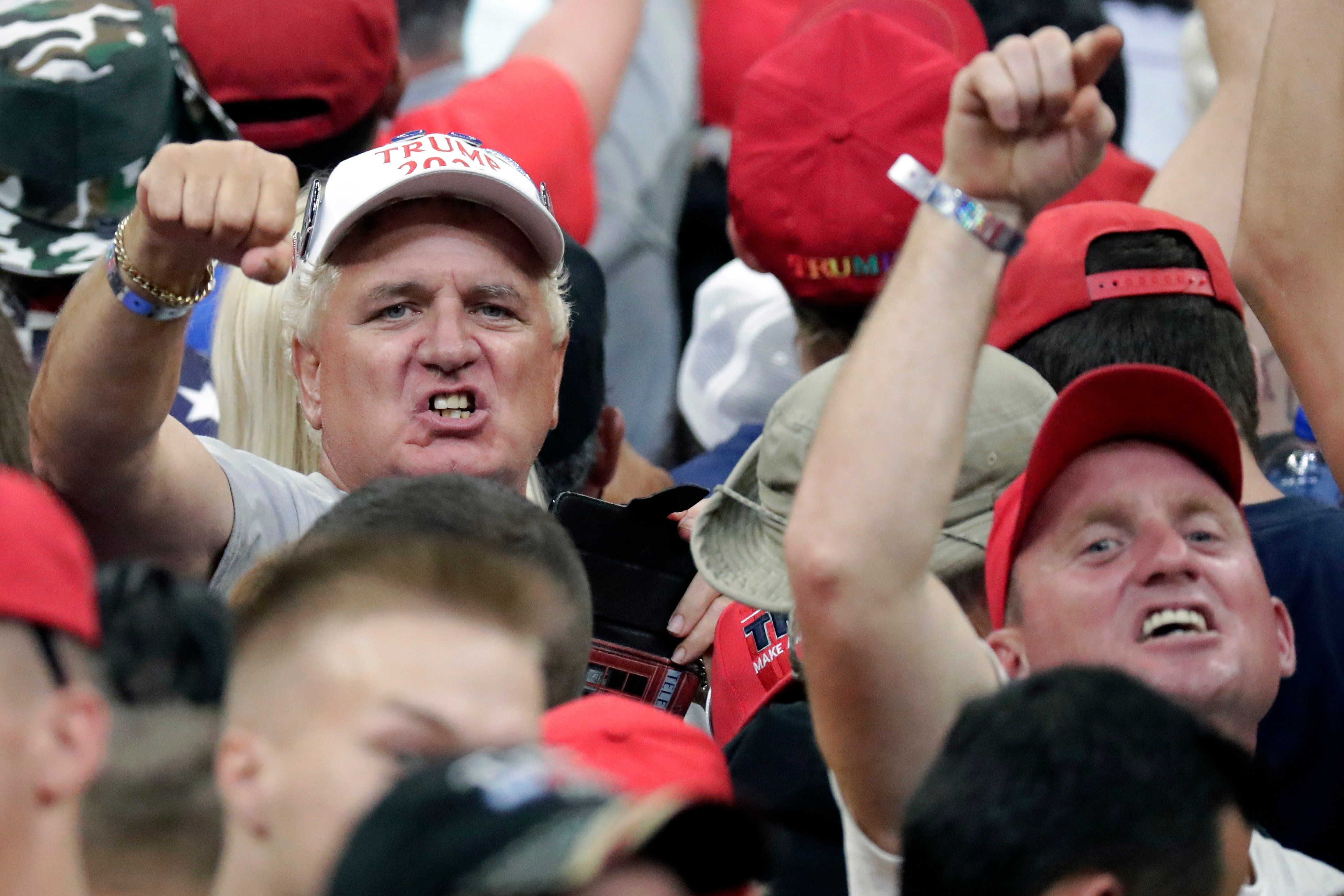 President Donald Trump supporters shake their fists at the media as Trump formally announced his 2020 re-election bid Tuesday, June 18, 2019, in Orlando, Fla