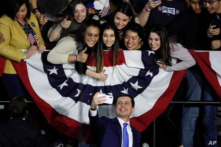 Democratic presidential candidate former South Bend, Ind., Mayor Pete Buttigieg takes a selfie with supporters after speaking…