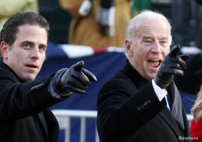 FILE - U.S. Vice President Joe Biden, right, and his son Hunter point to some faces in the crowd as they walk down Pennsylvania Avenue following the inauguration ceremony of President Barack Obama in Washington, Jan. 20, 2009.