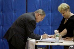 U.S. Sen. Bob Menendez checks in before casting his vote in the New Jersey primary election, June 5, 2018.