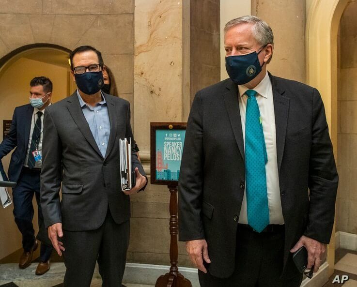 White House chief of staff Mark Meadows, right, and Treasury Secretary Steven Mnuchin, arrive at the office of House Speaker…