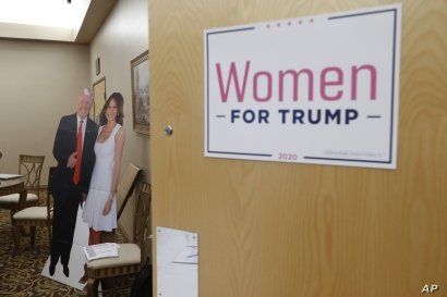 A cutout of President Trump and his wife Melania is shown outside a training session for Women for Trump, An Evening to Empower, in Troy, Mich., Aug. 22, 2019.